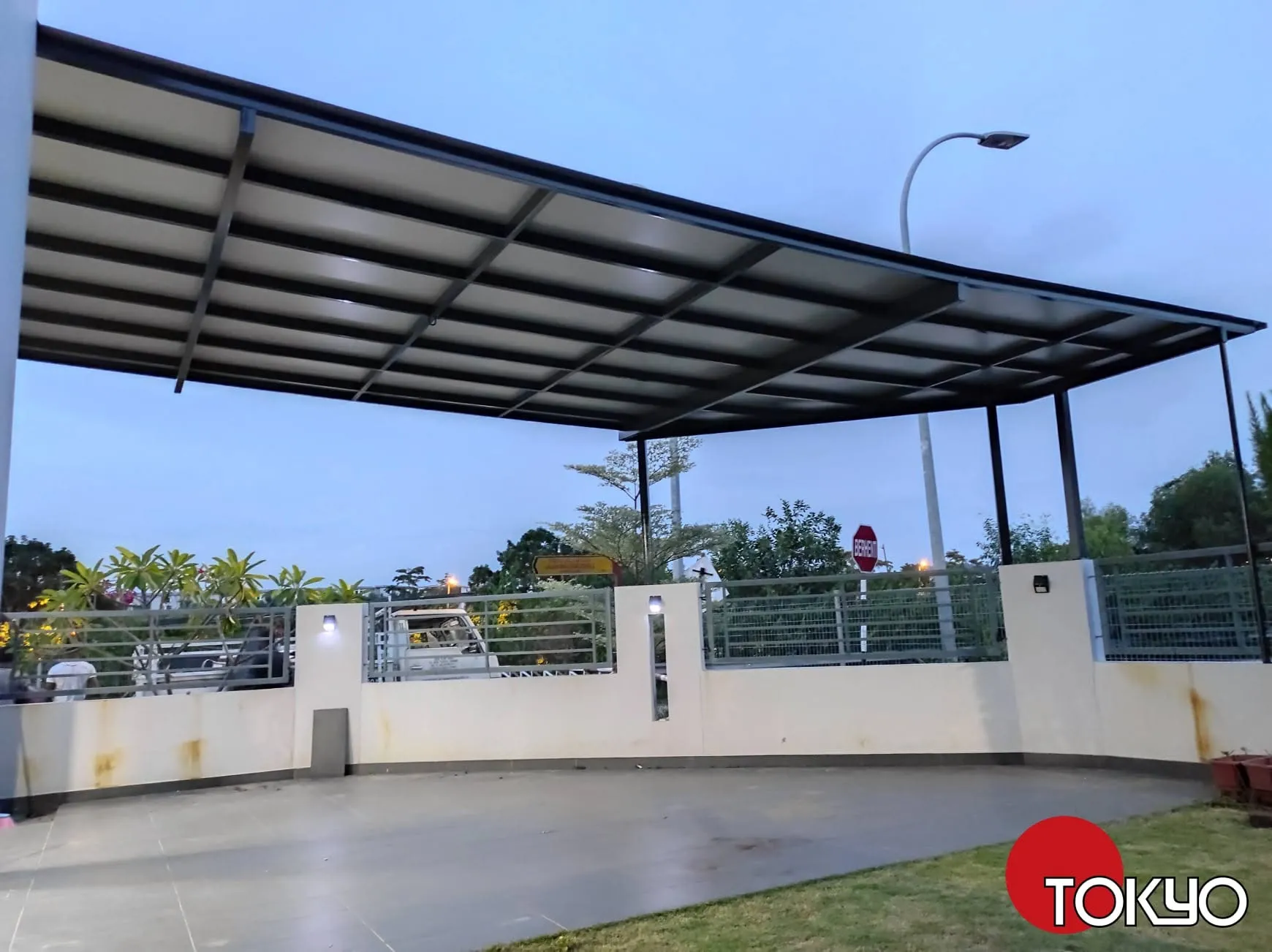 Metal PU sandwich panel roof over a driveway at dusk — real completed project serving the Bangi area