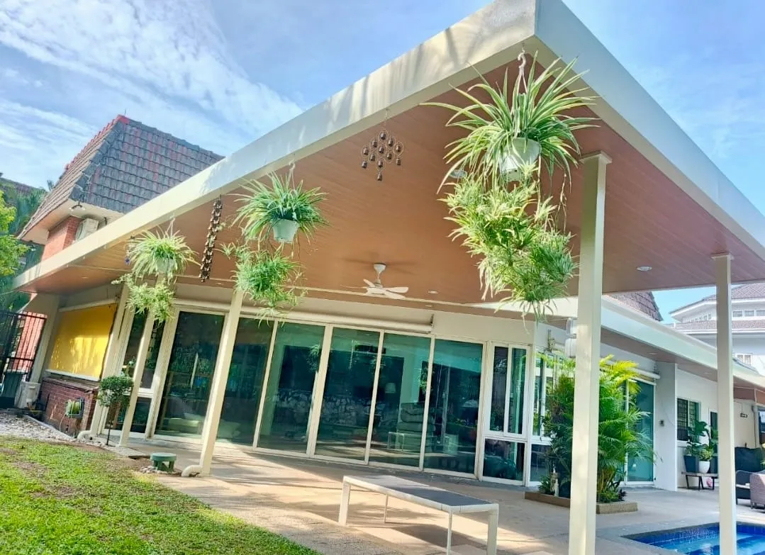 Wood-tone C-roof awning with aluminium slat ceiling over a poolside patio, installed by New Tokyo Awning