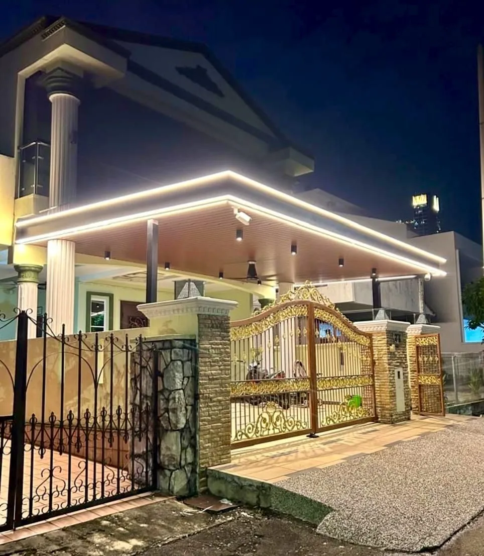 C-roof awning with LED ceiling lighting over a night-time driveway gate