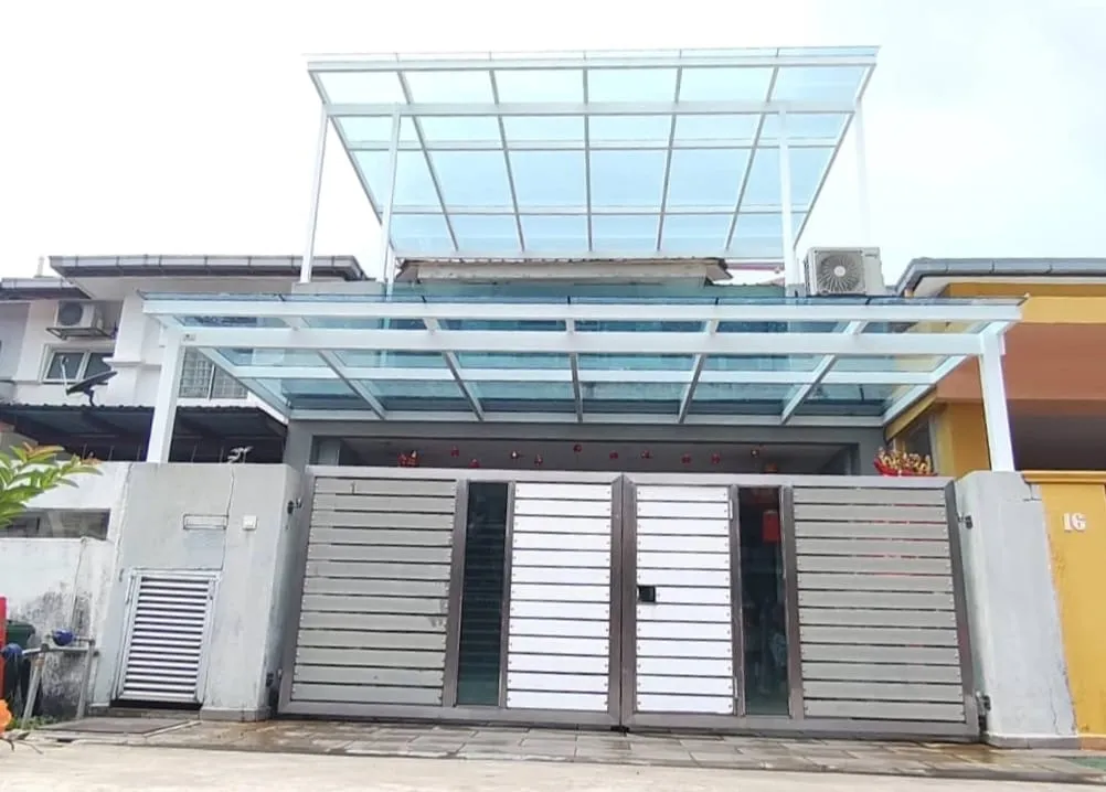 Glass roof awning installed over a driveway gate at a terrace house