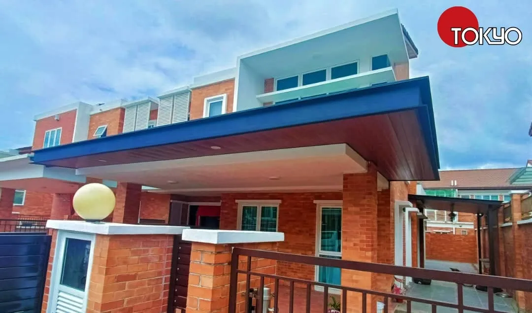 Navy-blue ACP roof awning over a car porch at a brick-accented double-storey house — real completed project serving the Semenyih area