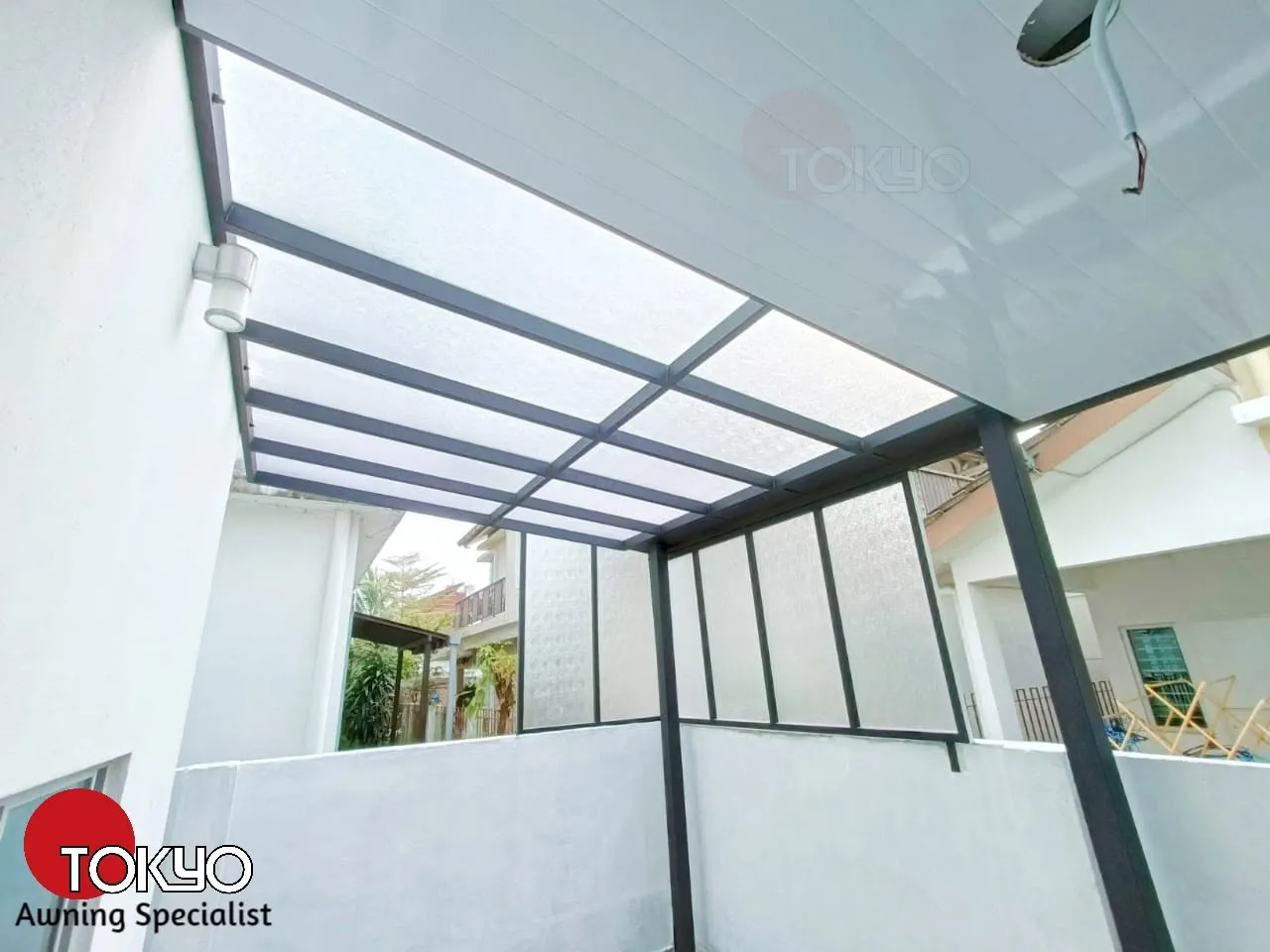 Frosted glass roof awning over a patio — real completed project serving the Serdang area