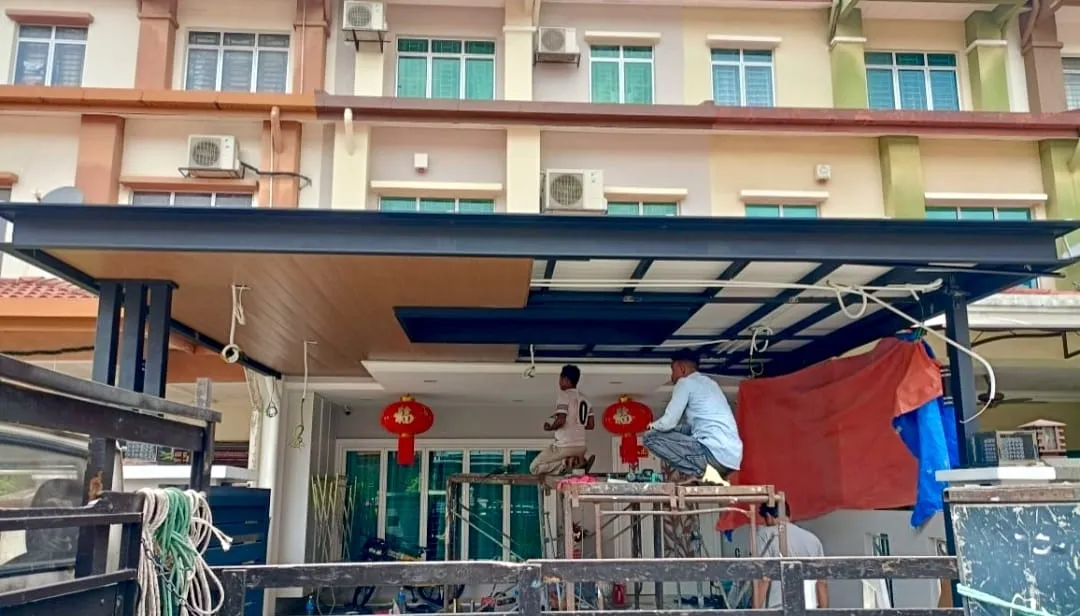 New Tokyo Awning installation crew fitting a roof awning frame at a terrace house in Kajang