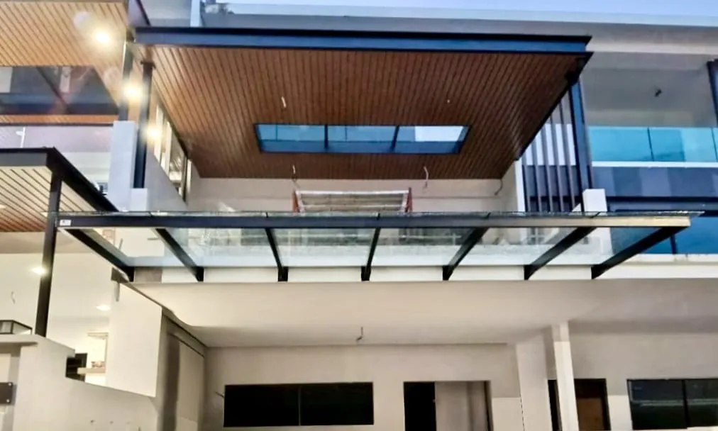 Completed glass roof canopy installed over an upper-floor balcony